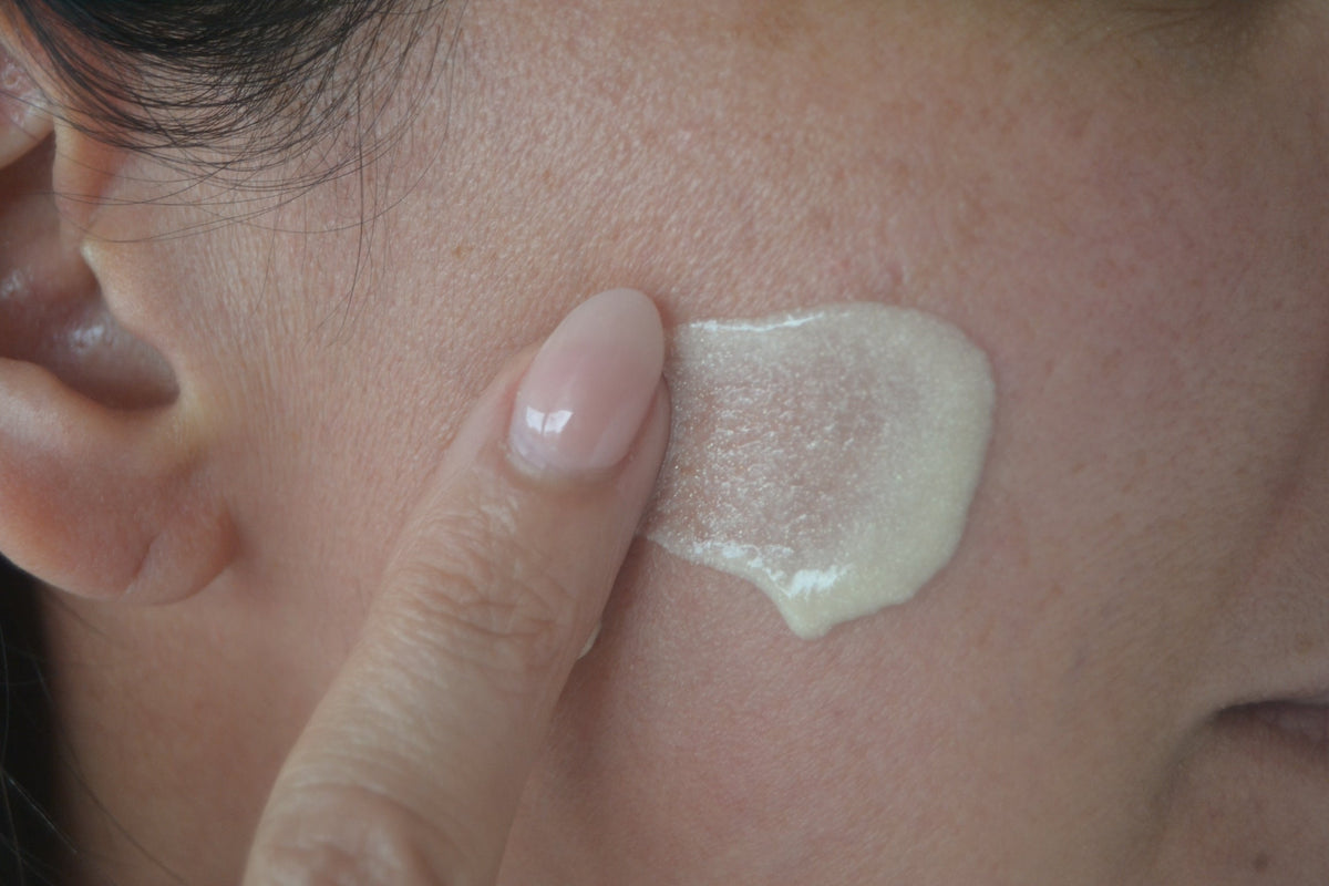 Close-up of skin texture applying moisturizer