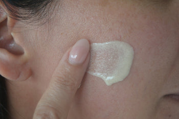 Close-up of skin texture applying moisturizer