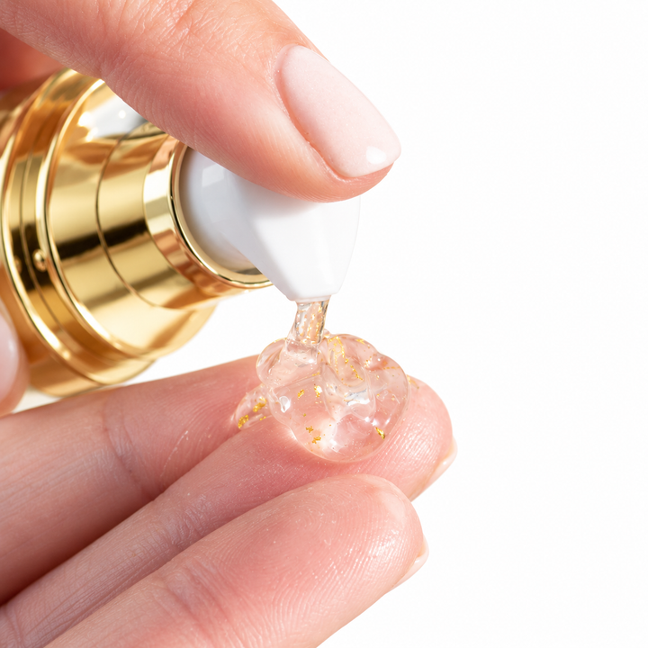 24K Gold Exfoliating Gel texture on finger by EMK Skincare