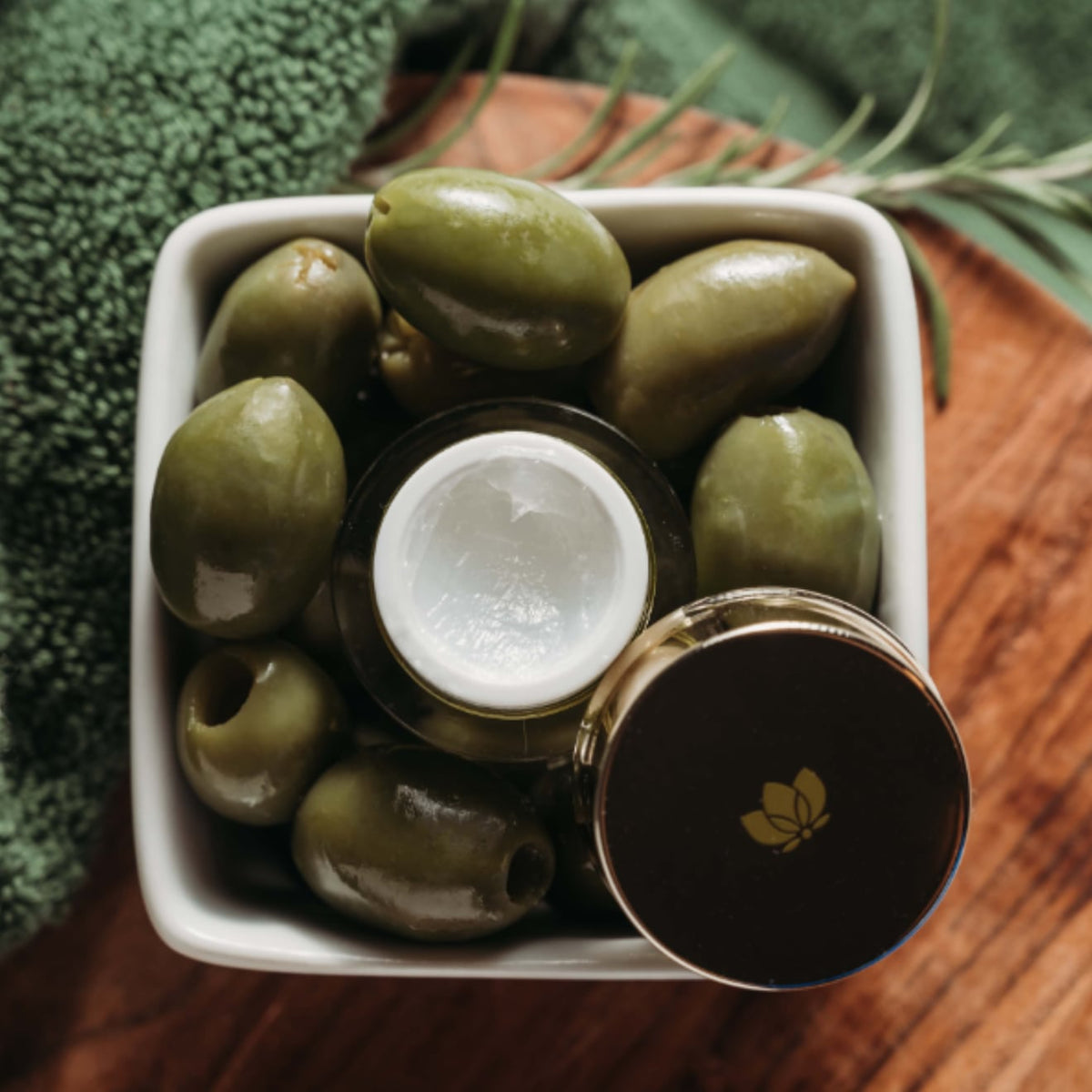 Face Treatment open jar in olive bowl by EMK Skincare
