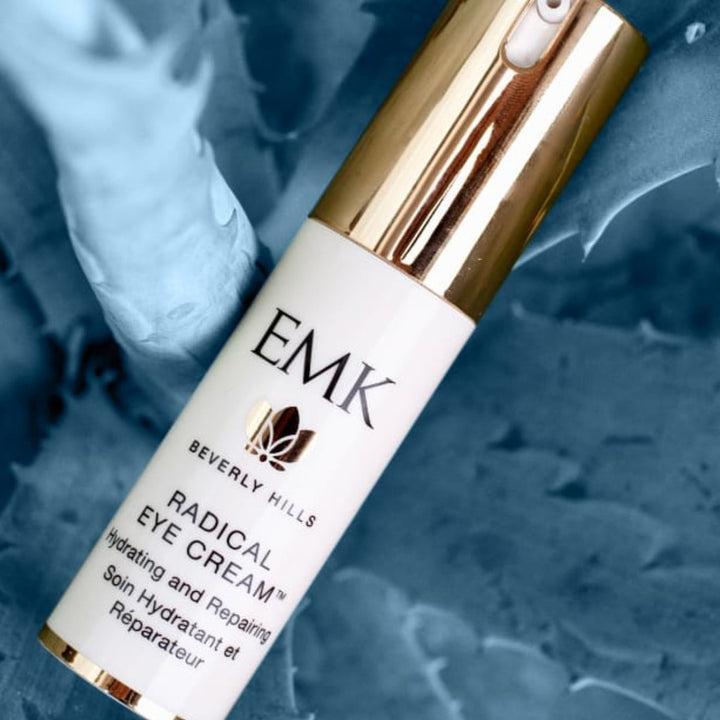 Radical Eye Cream bottle angled on dark background by EMK Skincare