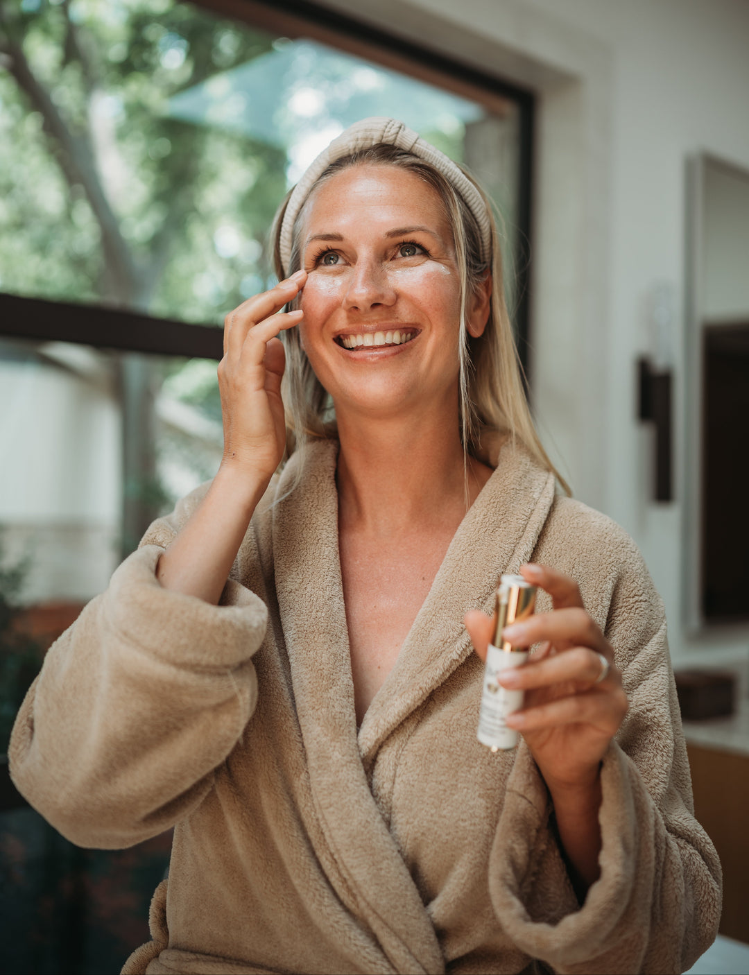 Model applying Radical Eye Cream morning routine by EMK Skincare