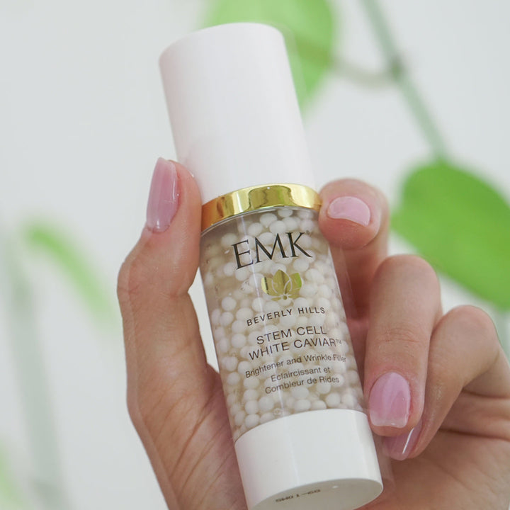Stem Cell White Caviar bottle held in hand by EMK Skincare