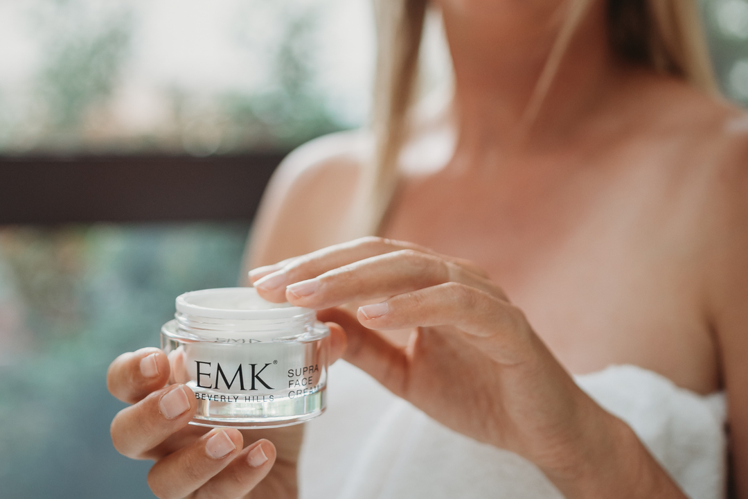Supra Face Cream open jar held in hands by EMK Skincare