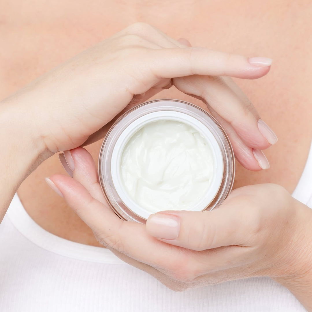 Supra Face Cream open jar held in hands by EMK Skincare